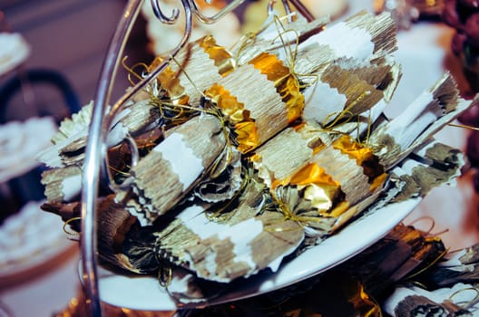 Chocolates wrapped in paper at a wedding candy table