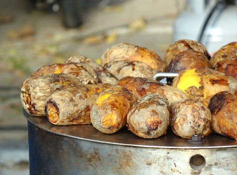 Freshly baked sweet potatoes are kept warm on top of the oven