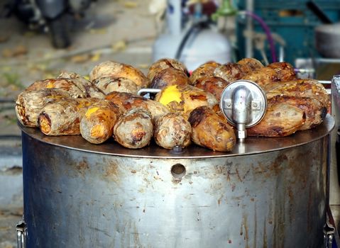 Freshly baked sweet potatoes are kept warm on top of the oven