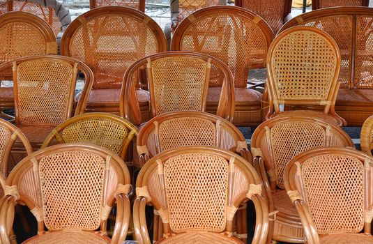 Handcrafted rattan and bamboo chairs for sale at an outdoor market