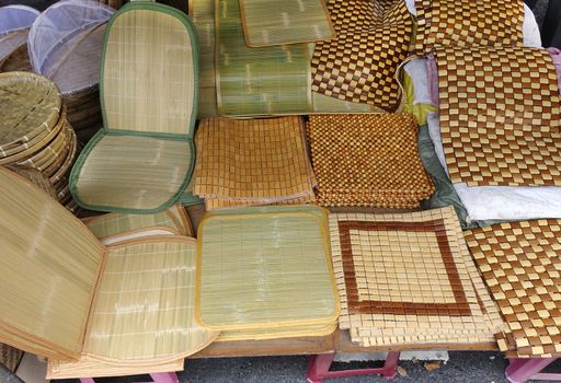 Handcrafted bamboo and wicker mats at an outdoor market