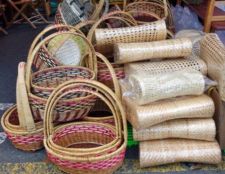 Handcrafted wicker baskets and pillows at an outdoor market