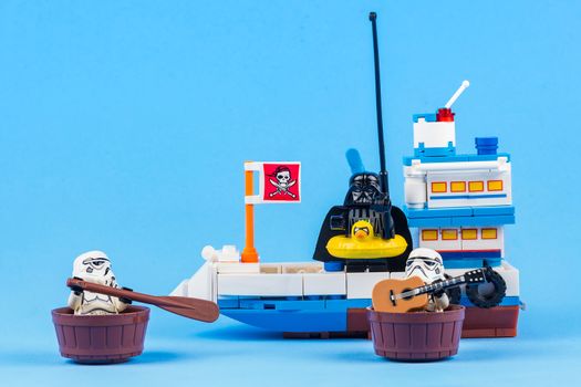 Bangkok, Thailand - June, 08, 2010 : Lego Star Wars Darth Vader is standing in the sea fishing on a fishing boat isolated on a blue background at Bangkok, Thailand. Fun concept
