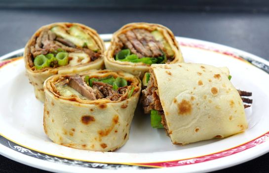 Rolled pancakes stuffed with beef, spring onions and sweet bean sauce is a popular Chinese snack