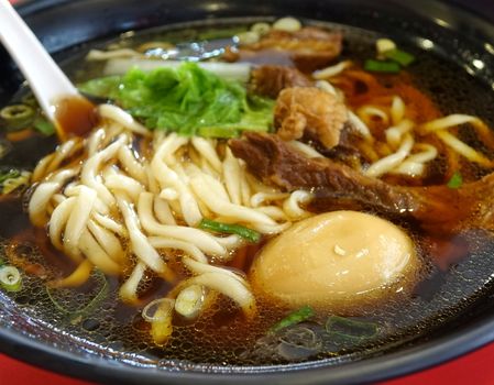 Braised beef in broth with noodles and chives is a popular dish in Taiwan