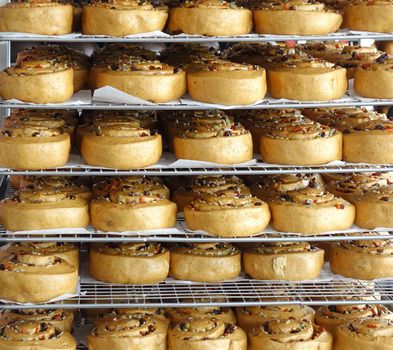 Chinese steamed buns with dried fruits and nuts on cooling racks

