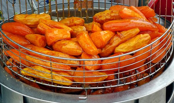 Baked sweet potatoes glazed with sugar are a popular Chinese snack