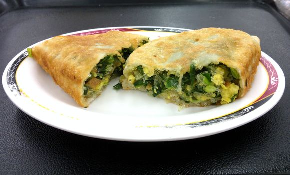 Fried pastry stuffed with chives, egg, tofu and noodles is a popular Chinese snack