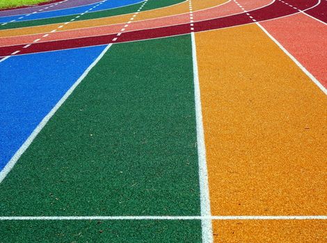 Running tracks in several bright colors with white lane markings

