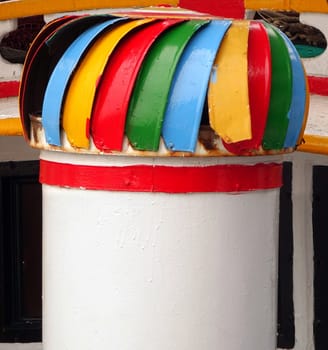 A colorful exhaust vent on a local fishing boat