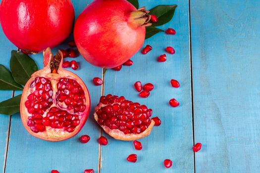 Ripe pomegranate fruits on the wooden background