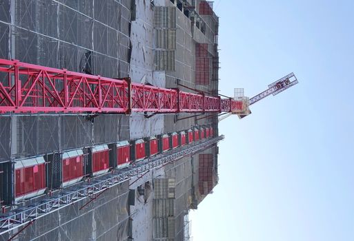 Large scale construction site with crane seen in perspective
