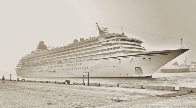 Vintage style image of a large cruise ship docking in port