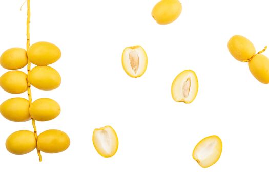 yellow date palm fruit on white background