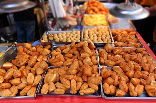 A market stall sells deep fried Chinese bread buns
