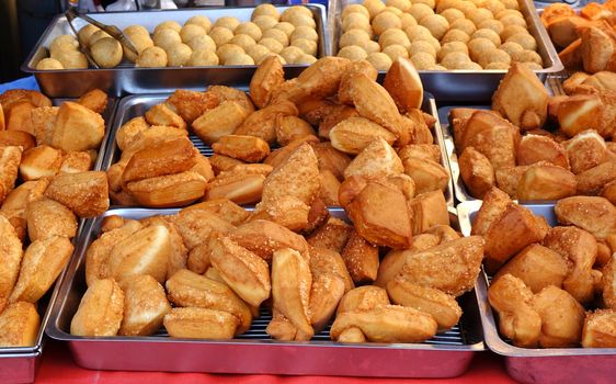 A market stall sells deep fried Chinese bread buns