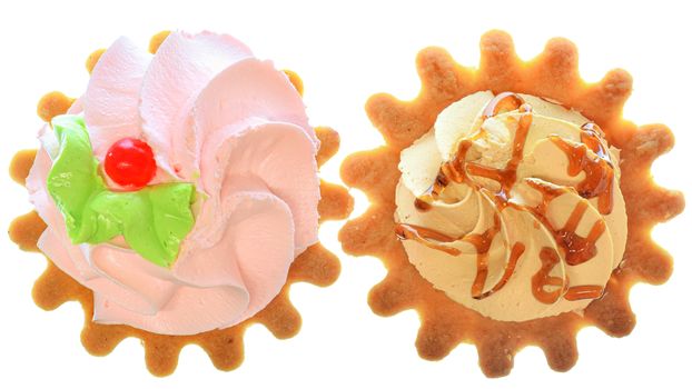 Two tartlet cake with strawberry cream and caramel filling, top view isolated on a white background.