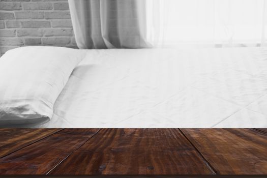 white pillow on mattress bed beside see through sheer window curtain