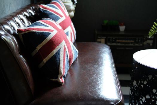 british flag pillow on brown leather sofa couch in living room interior