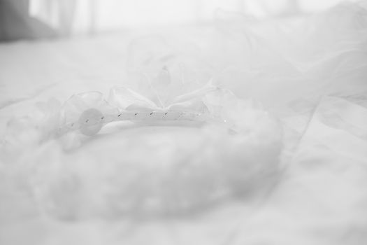 wedding white bridal veil on bed. tulle gathered in hair hoop . mesh fabric