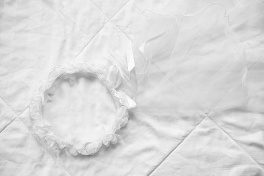 wedding white bridal veil on bed. tulle gathered in hair hoop . mesh fabric