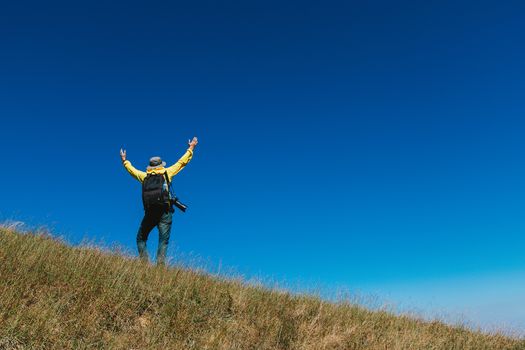 Silhouette of man hold up hands on the peak of mountain,success concept