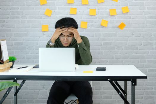 man freelancer feeling tired frustrated stressed from hard work. exhausted businessman have headache at workplace.