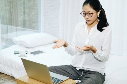 asian woman businesswoman talking with colleagues in online video conference meeting. work at home social distancing concept