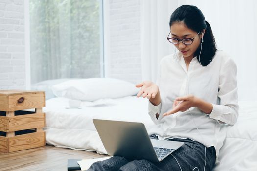 asian woman businesswoman talking with colleagues in online video conference meeting. work at home social distancing concept