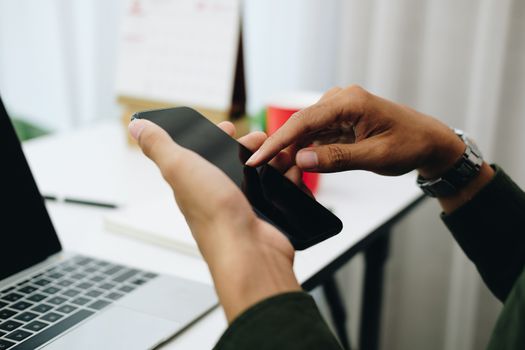 freelancer man businessman using mobile smartphone working at home office