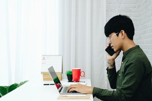freelancer man businessman talking on mobile phone working at home office