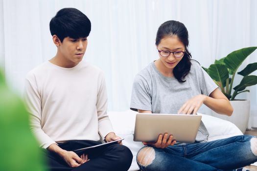 man woman friends using computer tablet. startup teamwork team working together at home