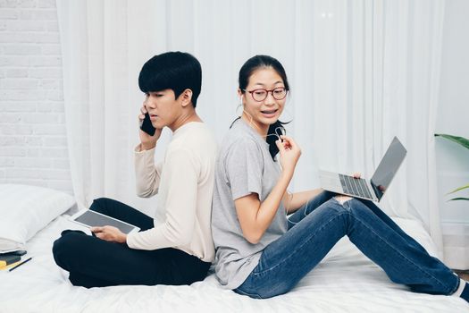 man talking on phone. woman using computer for online video conference meeting. tartup teamwork team working together at home