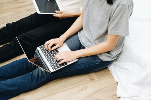 man woman friends using computer tablet. startup teamwork team working together at home