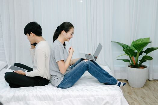 man talking on phone. woman using computer for online video conference meeting. tartup teamwork team working together at home