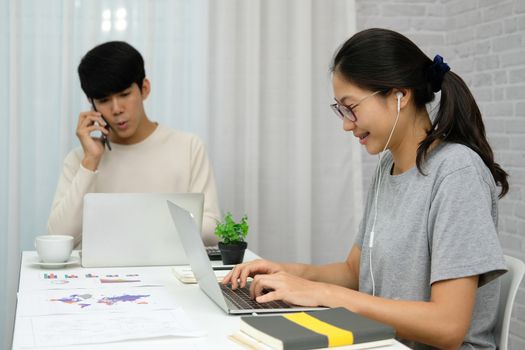 man talking on phone. woman using computer for online video conference meeting. tartup teamwork team working together at home