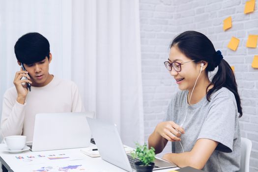 man talking on phone. woman using computer for online video conference meeting. tartup teamwork team working together at home