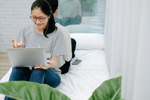 asian woman man talking with colleagues in online video conference meeting. work at home social distancing concept