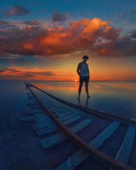 Male on beauty sunset on salty lake in Altay, Siberia, Russia