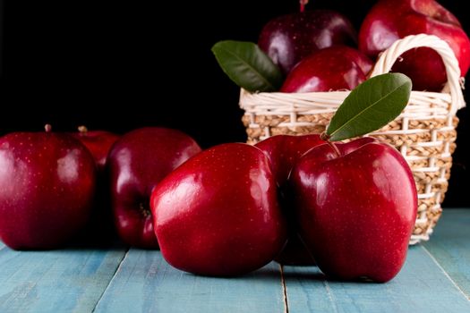 Red apples with leaves on the table