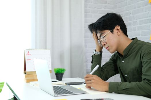 man freelancer feeling tired frustrated stressed from hard work. exhausted businessman have headache at workplace.