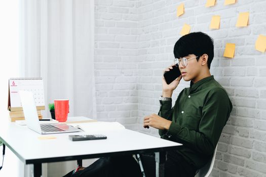 freelancer man businessman talking on mobile phone working at home office