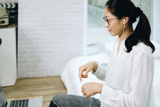 asian woman businesswoman talking with colleagues in online video conference meeting. work at home social distancing concept