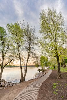 Grass block pavers forming a pathway close to the Dnieper river in the Natalka Park of Kiev, Ukraine, at the beginning of spring