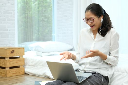 asian woman businesswoman talking with colleagues in online video conference meeting. work at home social distancing concept