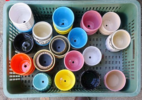 At the flower market a vendor sells ceramic flower pots
