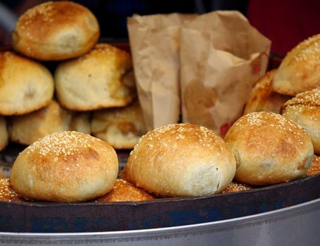 A street vendor sells freshly baked buns just out of the oven
