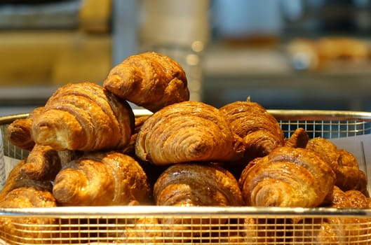 Freshly baked croissant buns in a tray