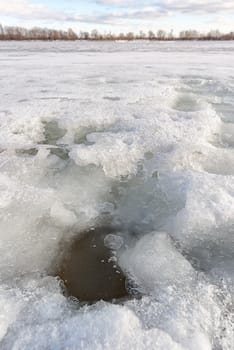 Detail of a hole in the ice on the frozen Dnieper river in Kiev, Ukraine, during a cold winter