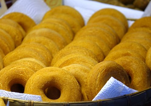 Stacks of fresh donuts are sold at an outdoor market